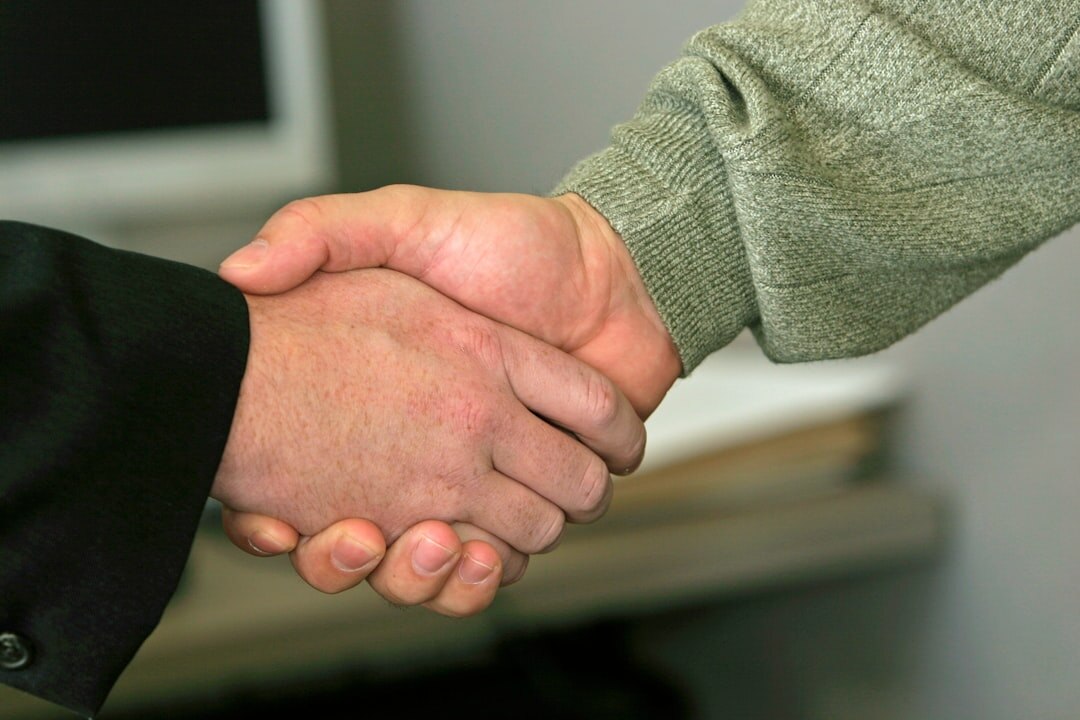 Two business professionals shaking hands after a meeting